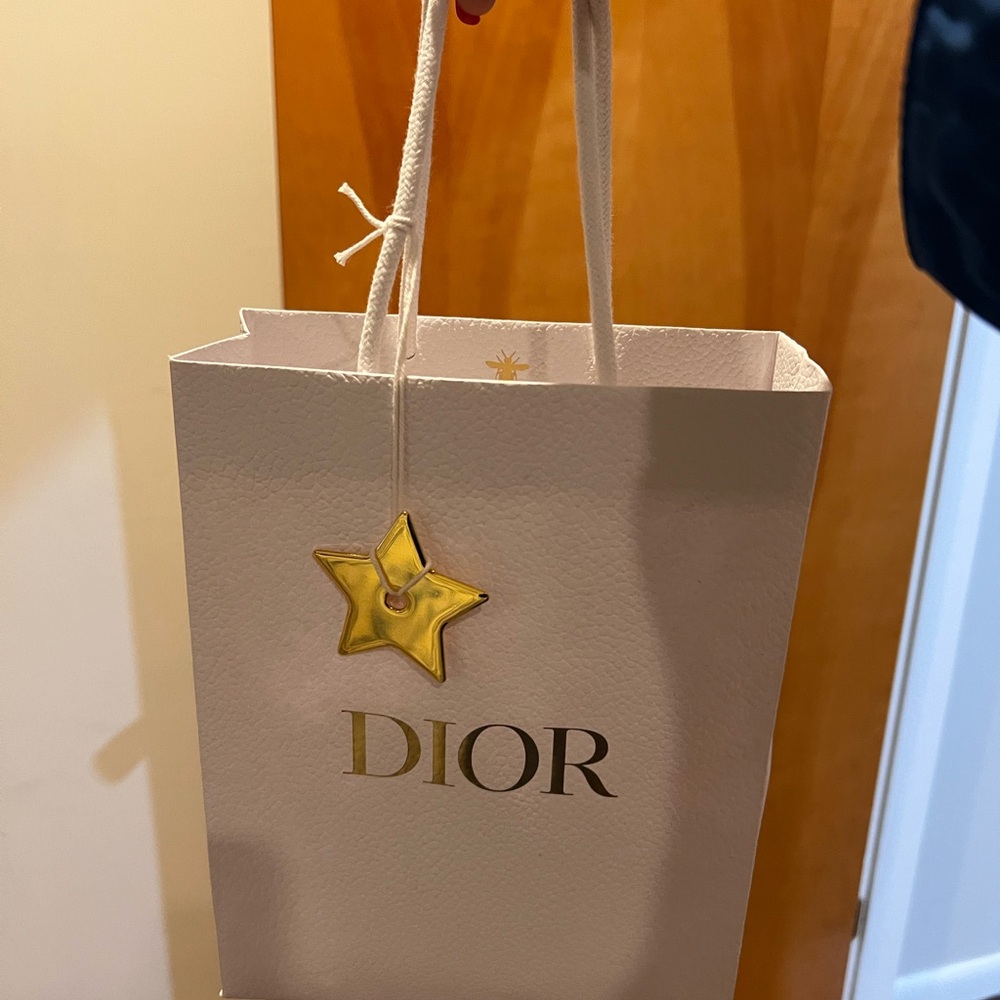 Authentic Dior White Bag with Gold Star Accent. Comes with ribbon as well